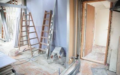 Construction site featuring ladders and tools in a home renovation setting.